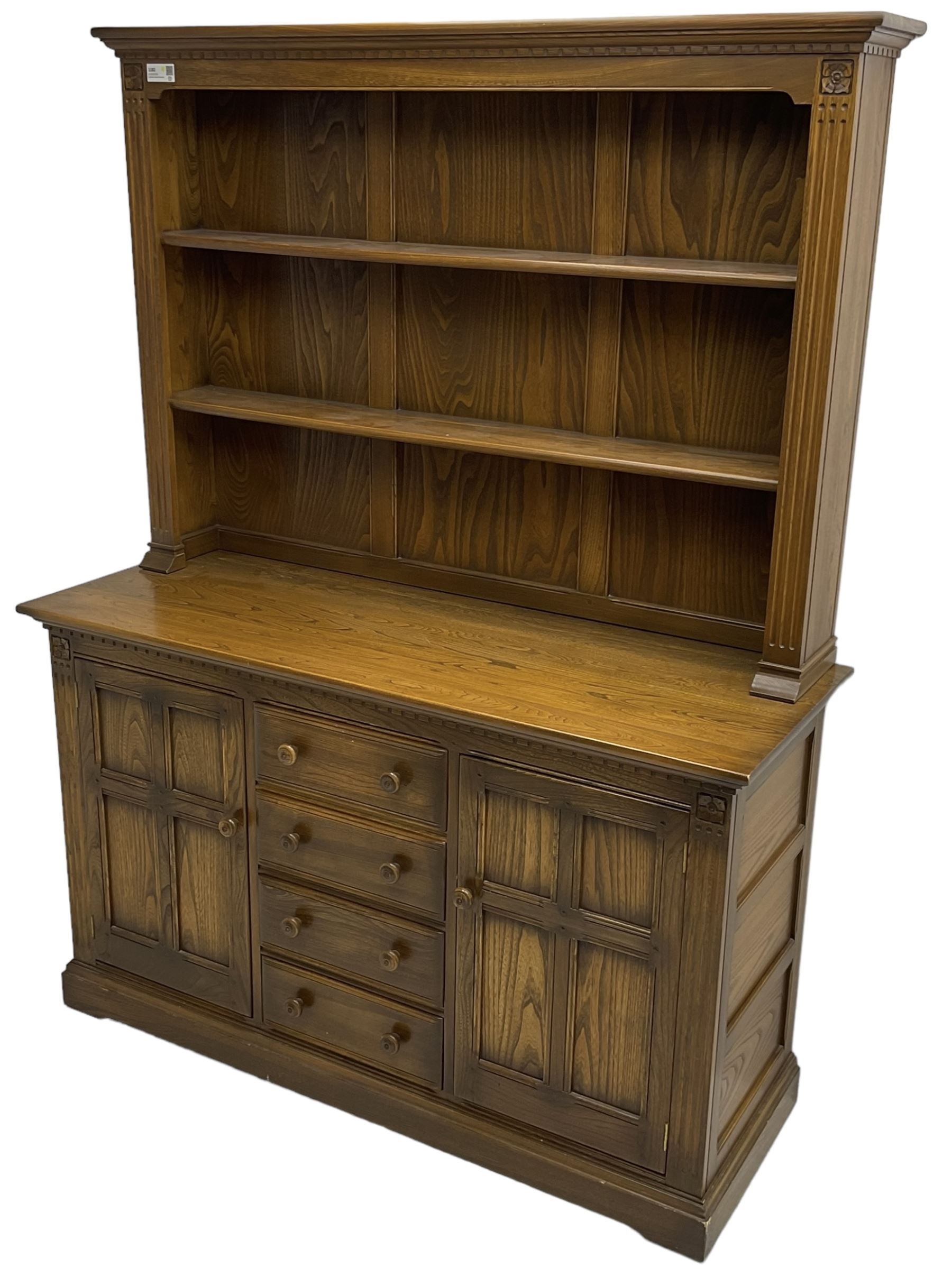 Ercol - mid-20th century dark elm 'Old Colonial' dresser, two tier plate rack with fluted uprights, base fitted with four drawers flanked by two panelled cupboards