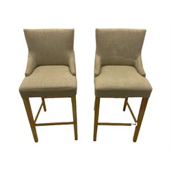 Pair of light oak bar stools, upholstered in beige fabric