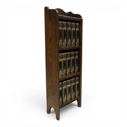 Small Edwardian mahogany open bookcase with Charles Dickens books, oak bookcase with galleried top, containing fifteen hardback books  
