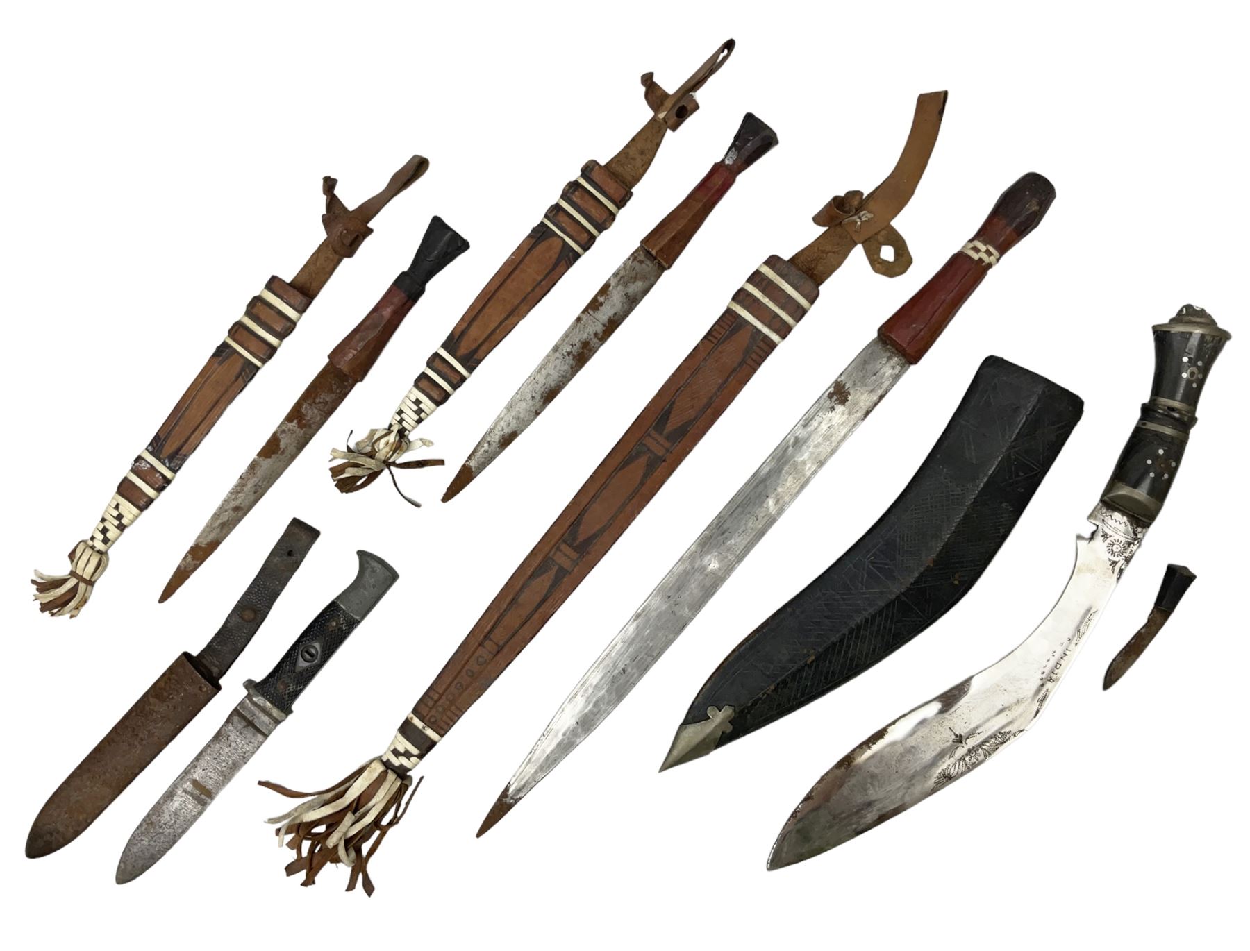 Indian kukri with 29cm curving steel blade and nickel mounted horn grip; in leather covered scabbard with one skinning knife L42cm overall; Hitler Youth knife with scabbard in relic condition; and three African graduated knives each with crudely carved wooden grips and painted leather covered scabbards (5)