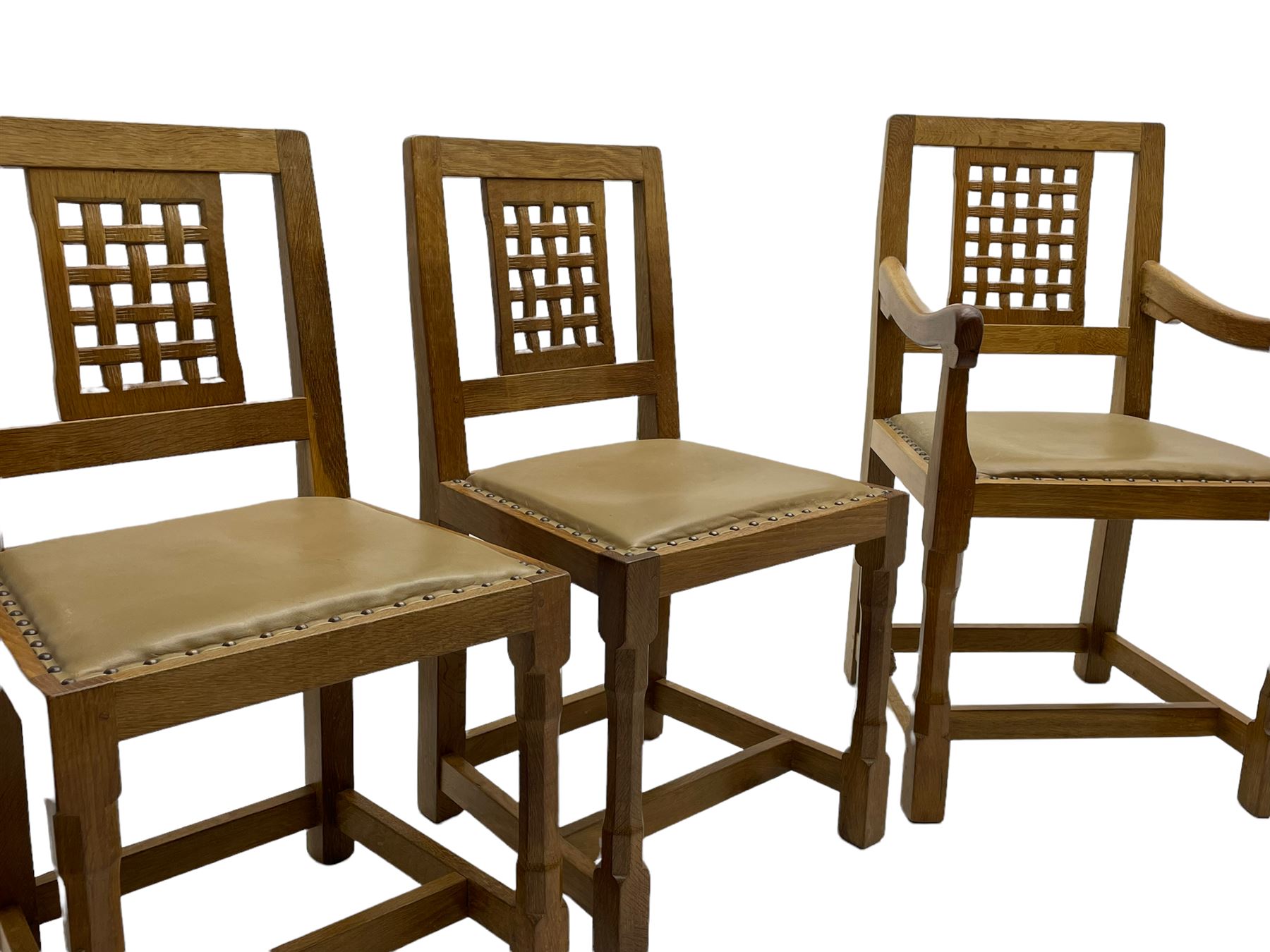 'Rabbitman' set of eight oak dining chairs, pierced lattice backs, upholstered seats with studwork band, octagonal front supports joined by stretchers, carved with rabbit signature, two carvers and six side chairs, by Peter Heap of Wetwang