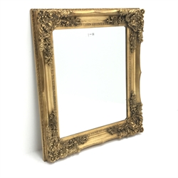 Bevelled edge mirror in ornate swept gilt frame,  69cm x 79cm