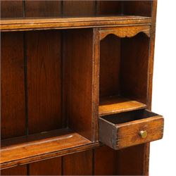 17th century style oak dresser, in the manner of Titchmarsh & Goodwin, fitted with a moulded top over three drawers and cupboard doors, the superstructure formed as a two tier panelled plate rack with integral trinket drawers