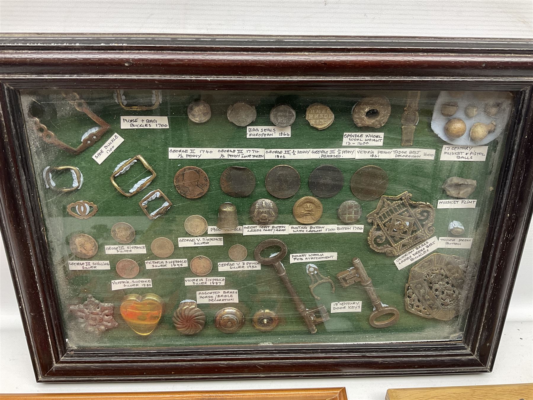 Collection of metal detecting finds and antiquities, housed on five display boards and some loose, to include coins, keys, axe head etc 