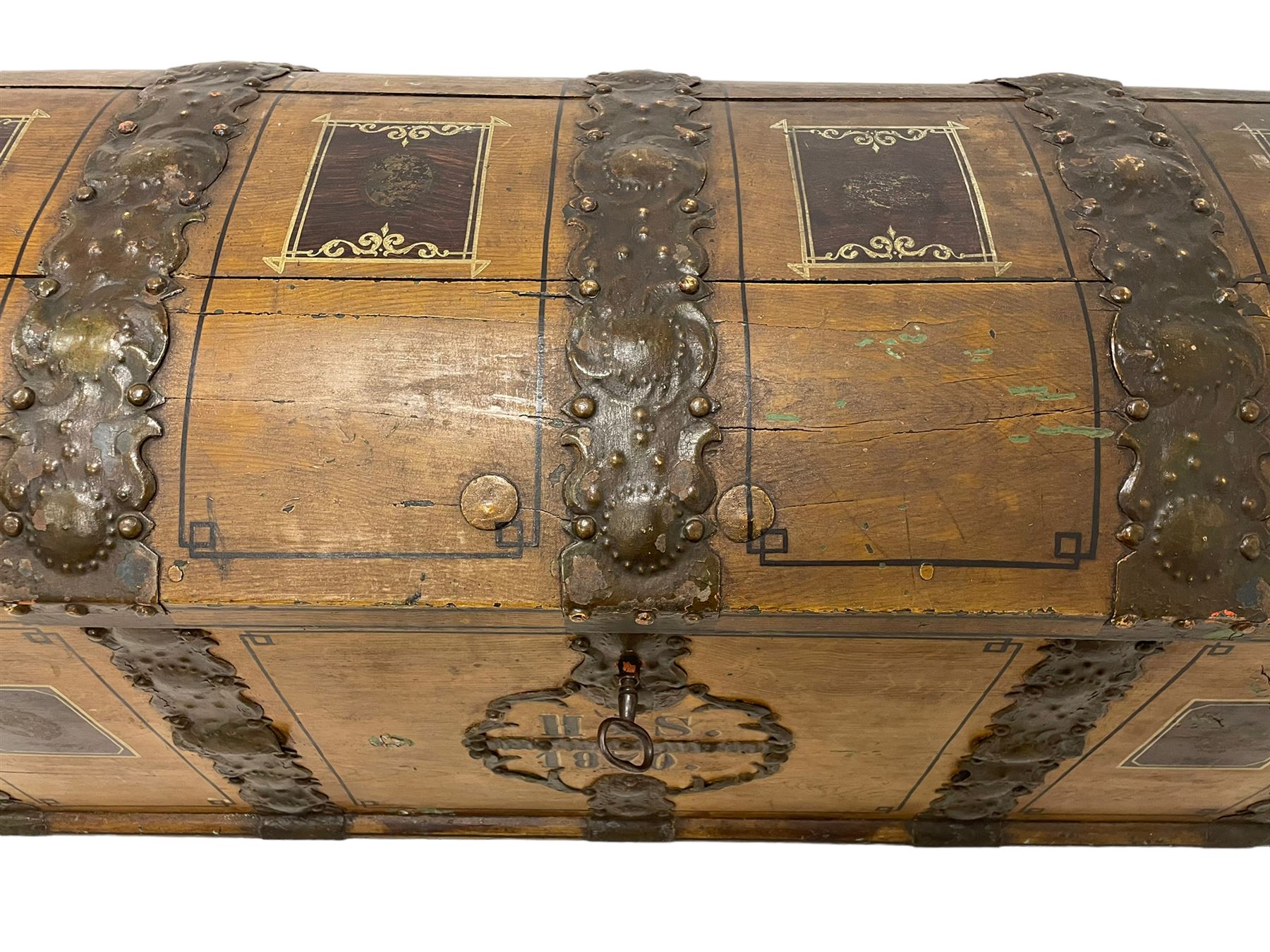 19th century painted oak sea chest, hinged dome top enclosing small compartment, bound by shaped and pressed metal strapwork, scumbled finish to resemble oak and painted with small vignettes depicting portraits and landscapes within panels, fitted with large wrought metal carrying handles, the front inscribed 'H.J.S. 1870' 