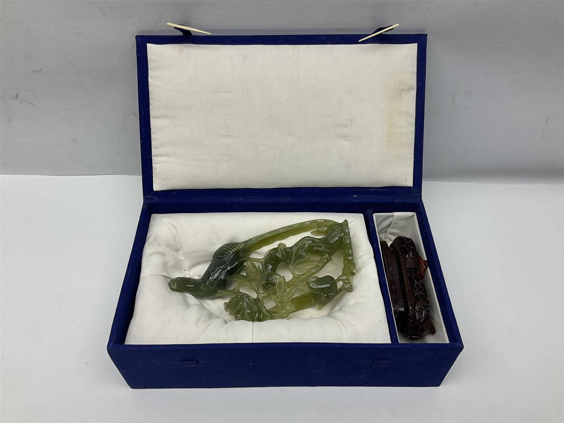 Carved jade figure of a phoenix perched on a flowering branch, upon a wooden stand, with original box, H27cm