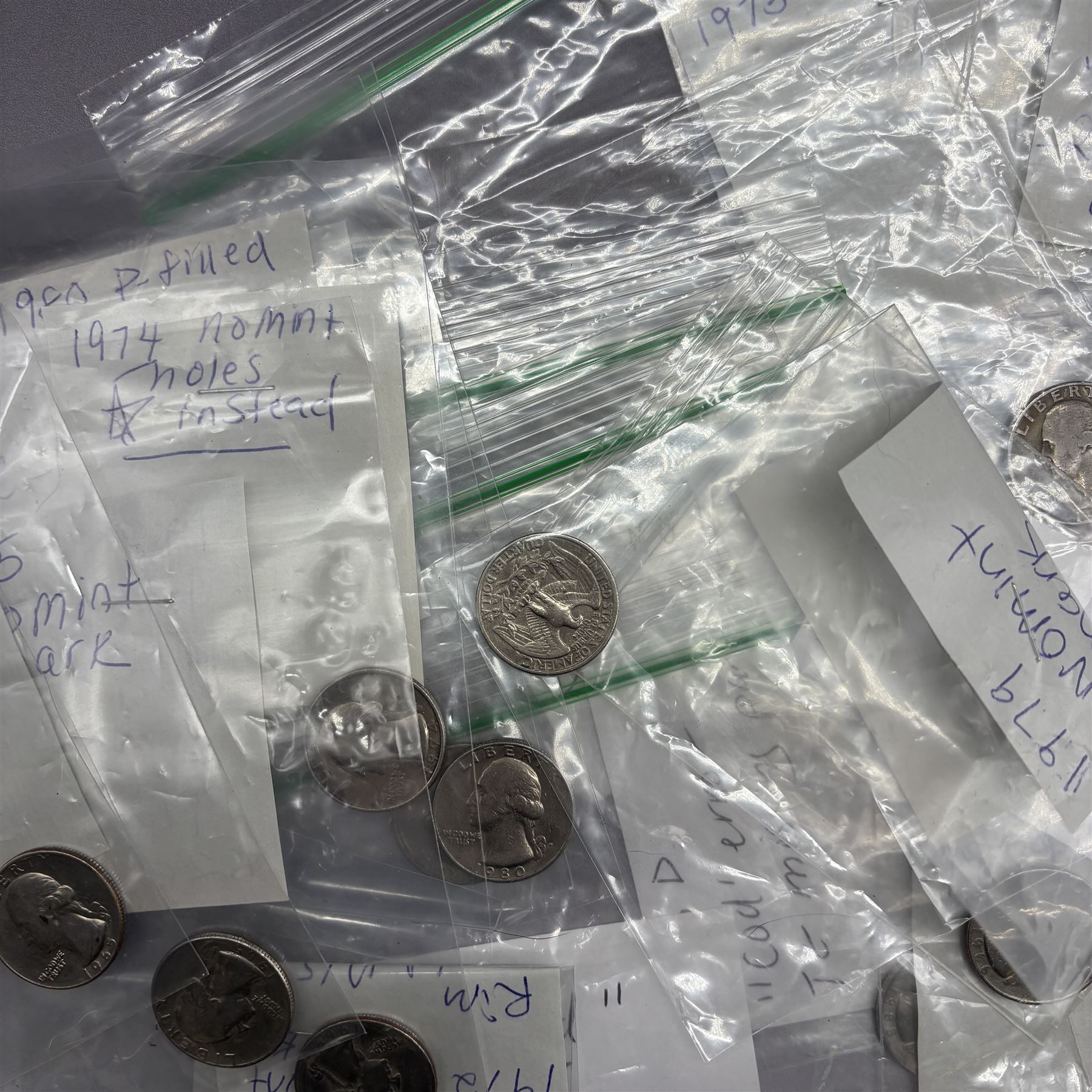 Collection of United States of America coins, 1965 onwards, principally quarter dollars, many with alleged minting errors as annotated on labels