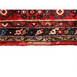 Persian crimson ground runner, the field decorated with Herati motifs,  three-band border, the main band decorated with repeating flowerheads 