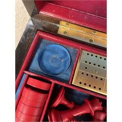 19th century walnut and brass bound games compendium box, painted to enhance the grain, of rectangular form, the hinged opening cover with rounded sides, central brass cartouche with engraved lion crest, and brass riveted straps, opening to reveal a red leather and blue silk lined compartmented interior, with fold-down games board, and lift-out tray containing playing cards, ebony turned dice towers, white and red stained bone draughts, and chess pieces, ivory dice, and ivory and ebony whist markers, and brass bezique board, cribbage board and markers, H15cm W32cm D24cm
This lot has been registered for sale under Section 10 of the APHA Ivory Act