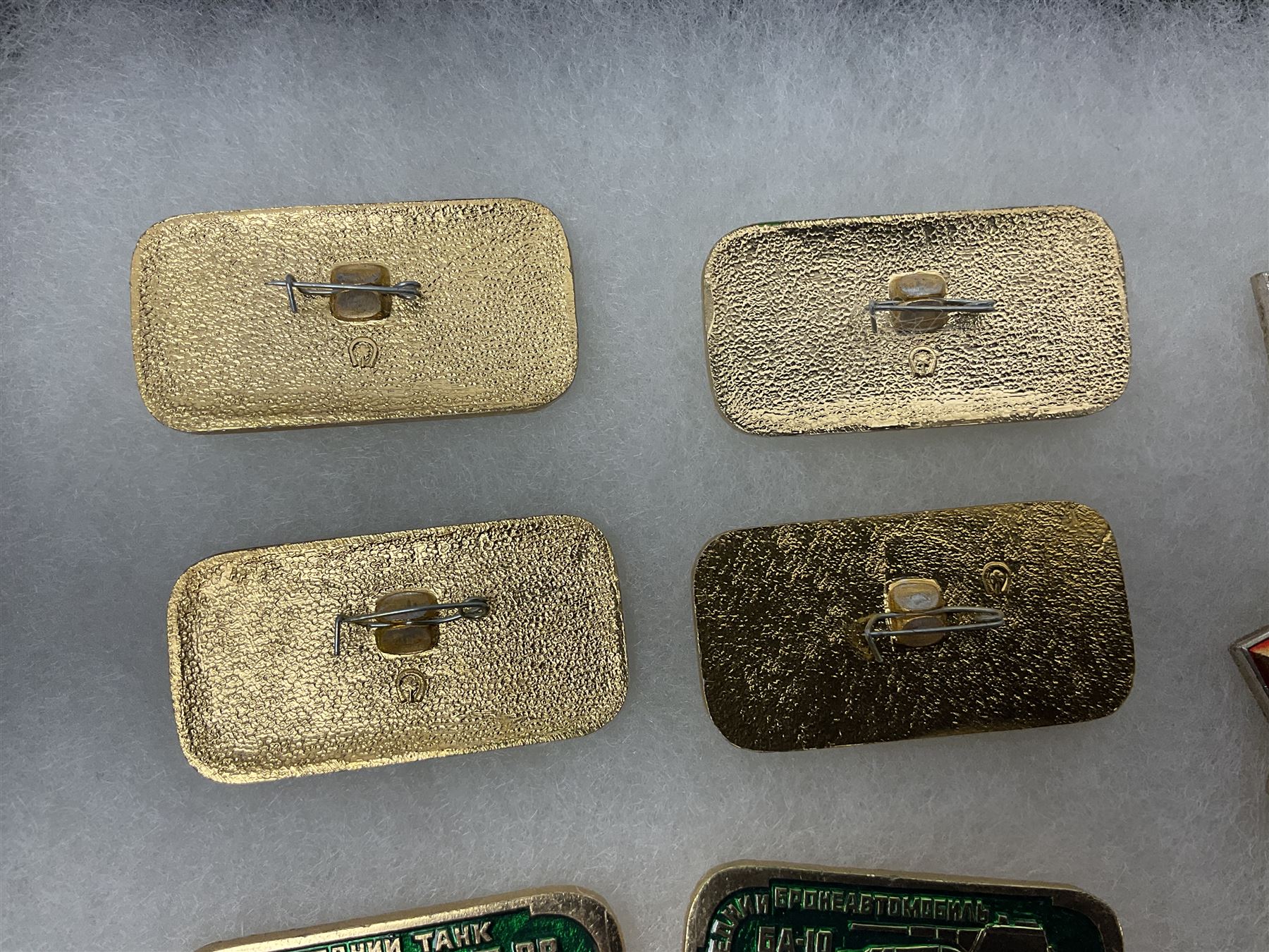 Nineteen Russian Soviet Tank Commemoration badges and medals, in small display case