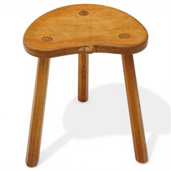 Mouseman - oak three-legged stool, dished kidney-shaped seat, raised on three octagonal splayed supports, with carved mouse signature, by the workshop of Robert Thompson of Kilburn