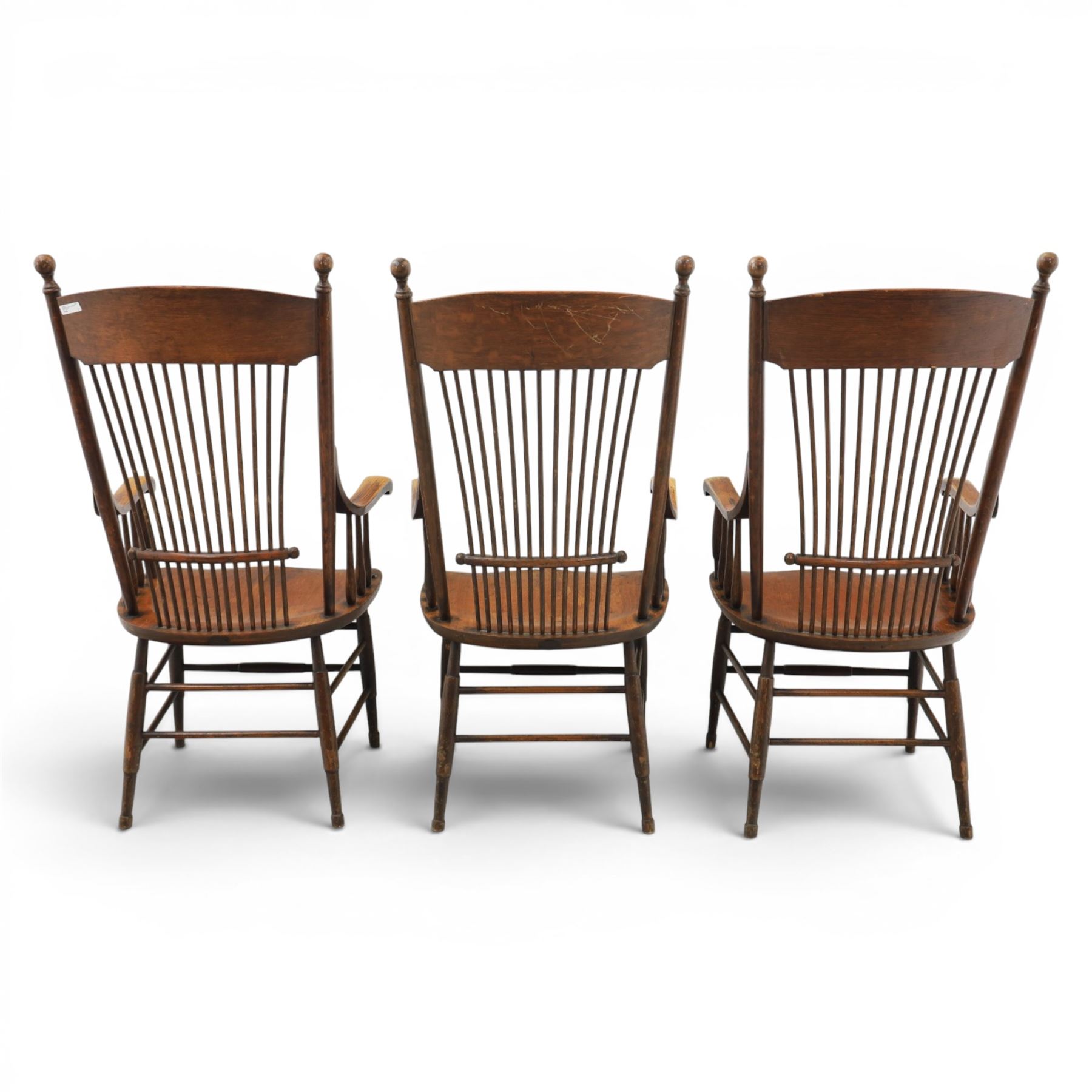 Set of three 19th century ash and elm spindle back Windsor armchairs, arched top rails above fan-shaped spindle backs, curved arms with turned supports, shaped saddle seats, on turned legs joined by H-stretchers