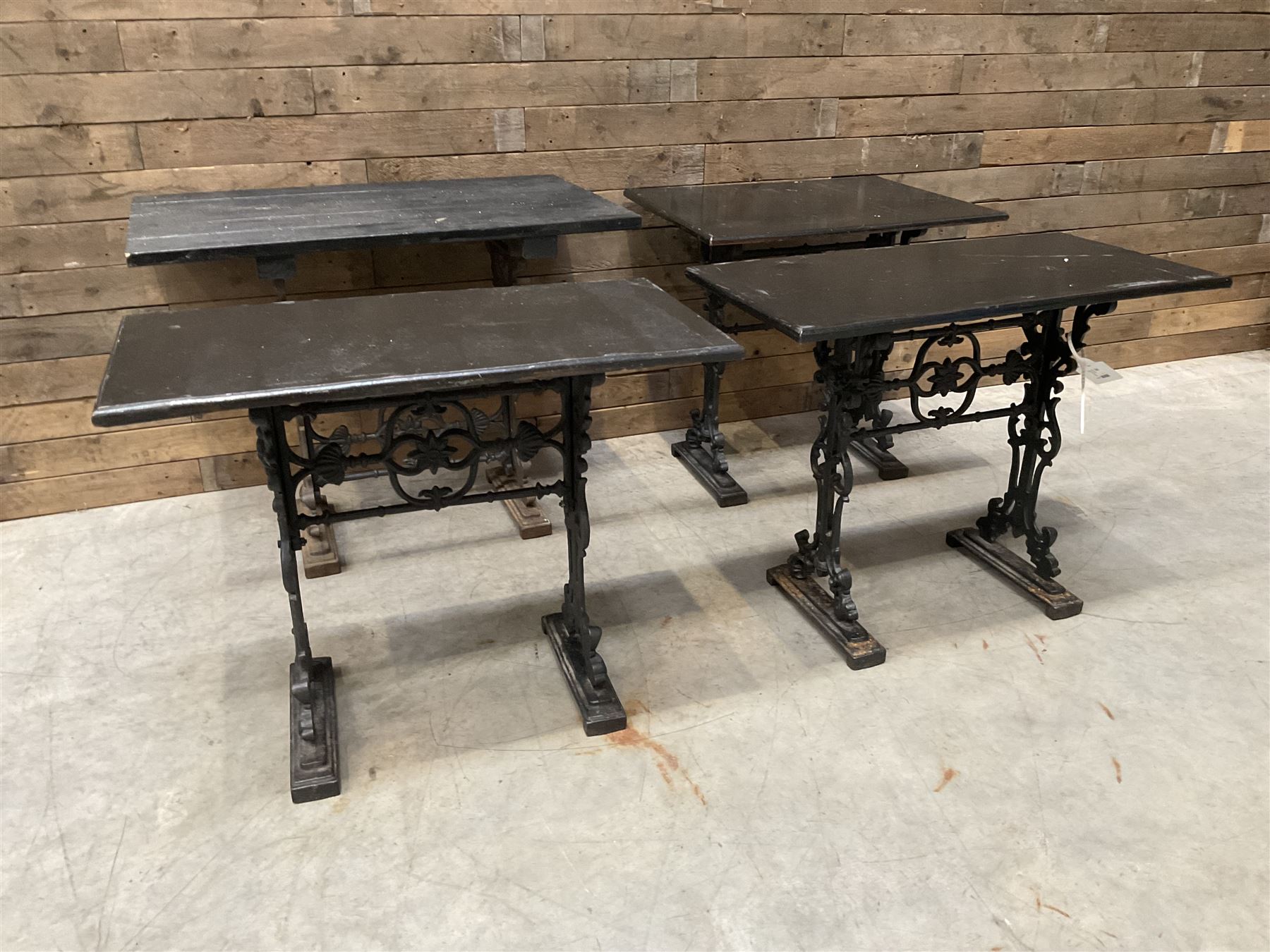 Four cast iron pub or bar tables with rectangular tops