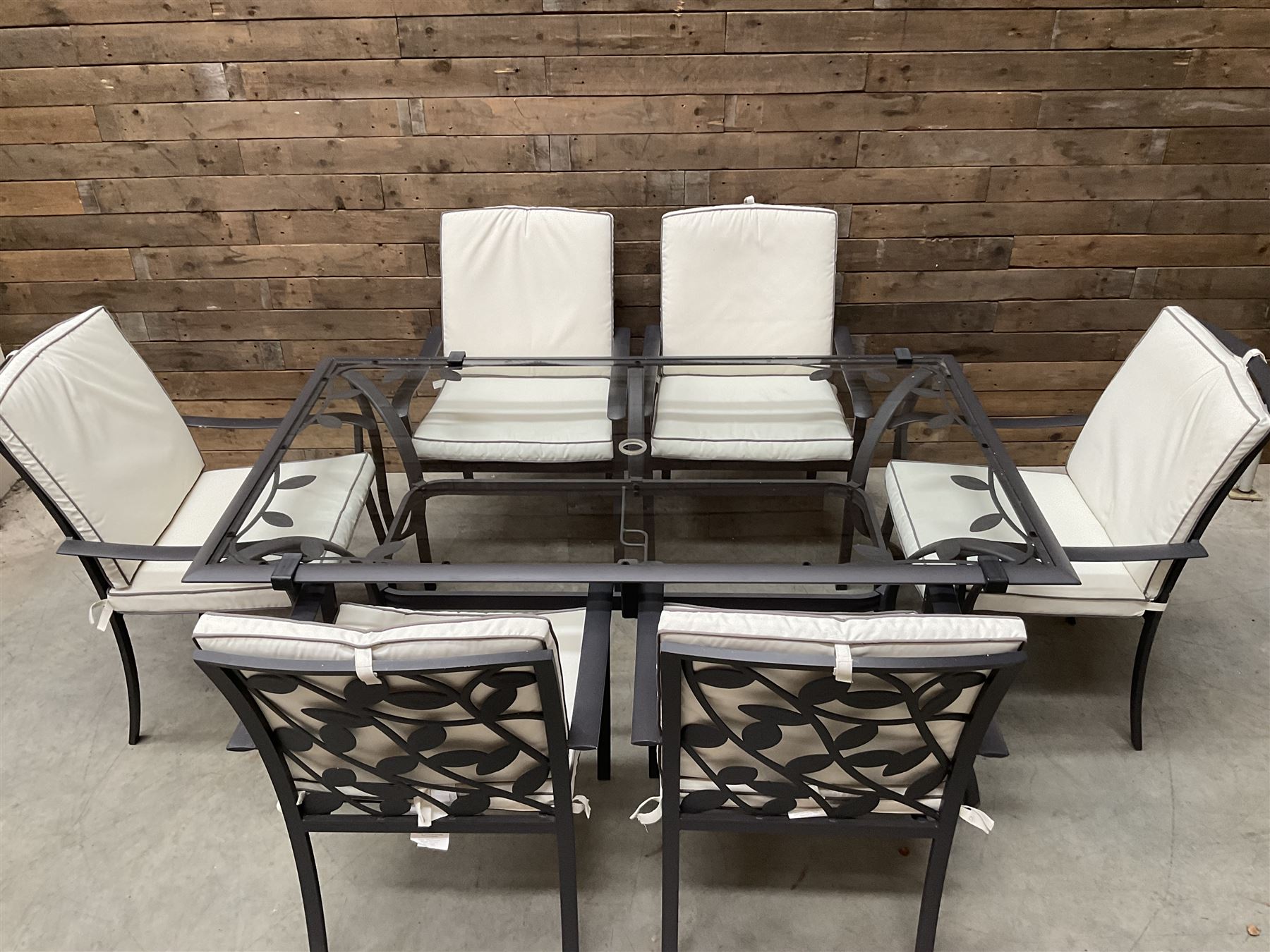 Metal framed garden table with glazed top (W170cm, D102cm, H71cm) and six armchairs with cushions 
