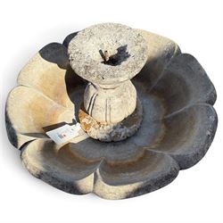 Weathered cast stone garden water feature fountain, the raised central spout with egg-and-dart moulding, within a scalloped basin raised on a lappet pedestal with cylindrical plinth base