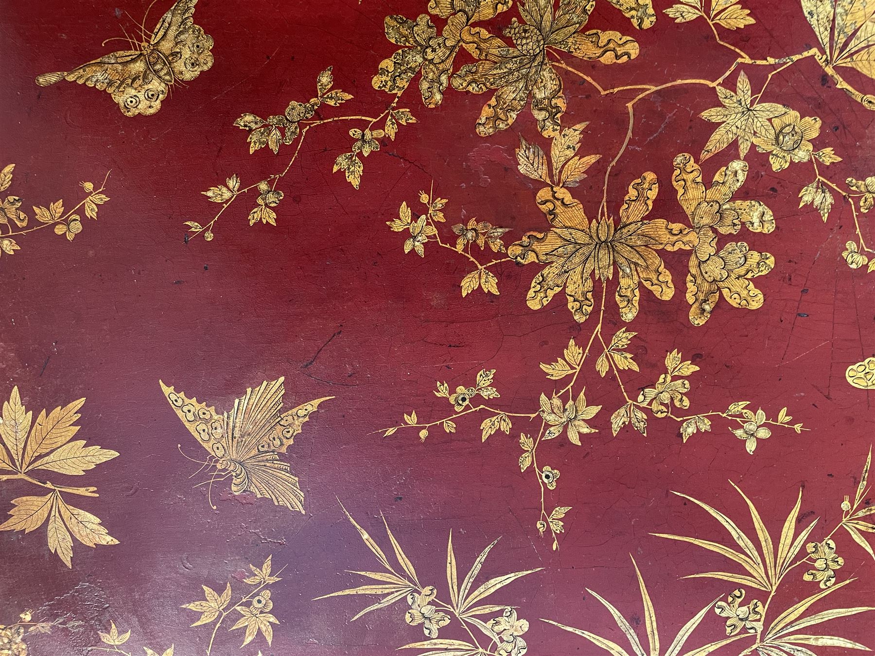 Early 19th century red lacquered papier-mâché tray by Clay of King Street Covent Garden, of rounded rectangular form, painted in gilt with large foliate sprays and butterflies, impressed verso CLAY KING ST COVENT GARDEN, W66.5cm D48.5cm