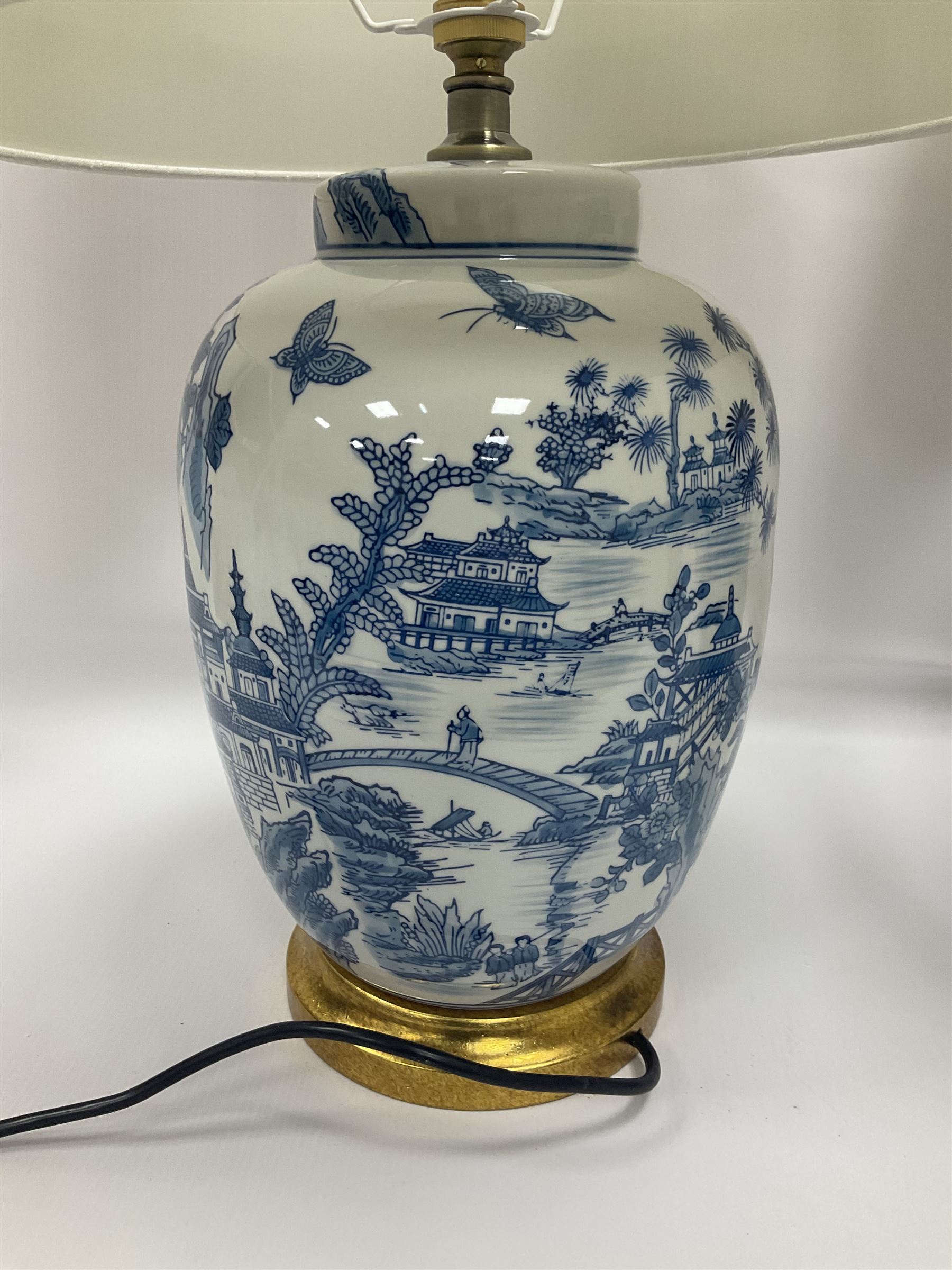 Pair of Chinese table lamps of baluster form, each decorated with landscape scene, raised upon gilt circular base, including shade H63cm