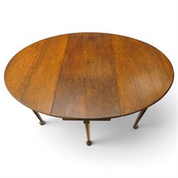 George III oak six-legged drop-leaf dining table, the oval drop-leaf top over six gate-leg supports with pad feet