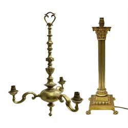 Heavy gilt table lamp of Corinthian column form, raised upon square stepped base with four claw feet, H50cm excl fitting, together with heavy three branch brass chandelier, L60cm