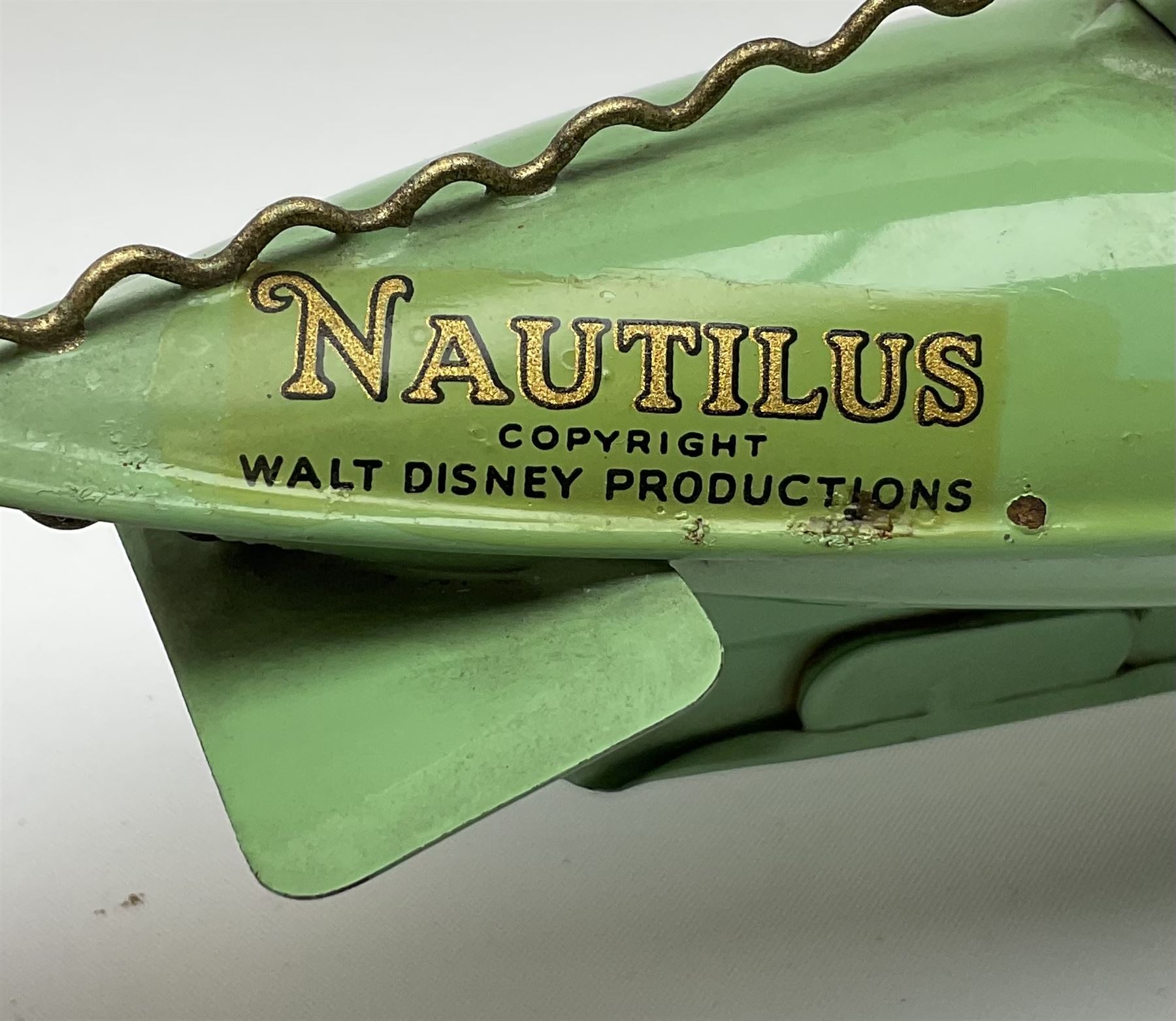 Sutcliffe Models ‘Nautilus’ tinplate and clockwork submarine from Walt Disney’s ’20,000 Leagues Under The Sea’ by Jules Verne, sea green body with various decals, rubber bung with periscope, boxed with inner cardboard display piece, produced between 1955-1960