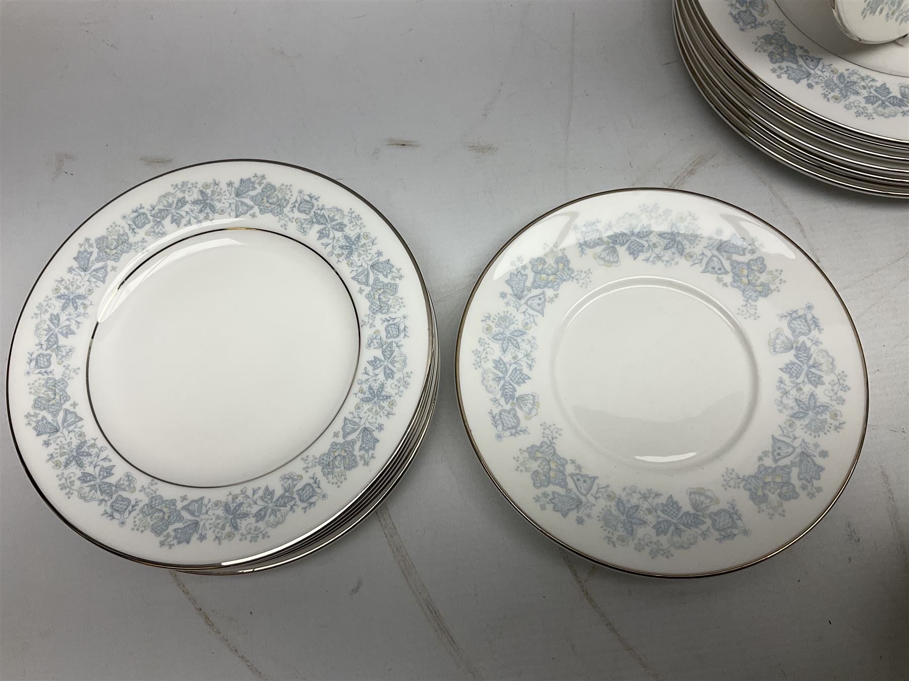 Royal Doulton tea and dinner wares in the Meadow Mist pattern, no H5007, comprising seven dinner plates, eight side plates, two lidded tureens, two jugs, lidded sucrier, oval serving dish, six teacups, seven saucers, seven tea plates and large saucer