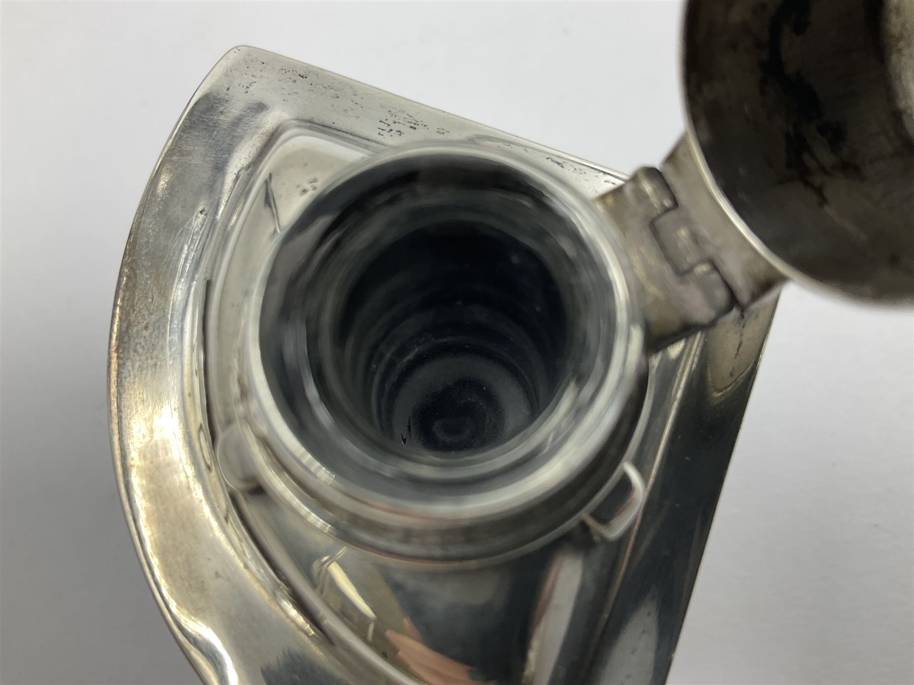 Early 20th century silver novelty inkwell, modelled as a ship's port lantern, with swing handle, convex red glass panel and hinged cover opening to reveal a glass liner, hallmarked Samuel Jacob, London 1911, height not including handle H8.5cm