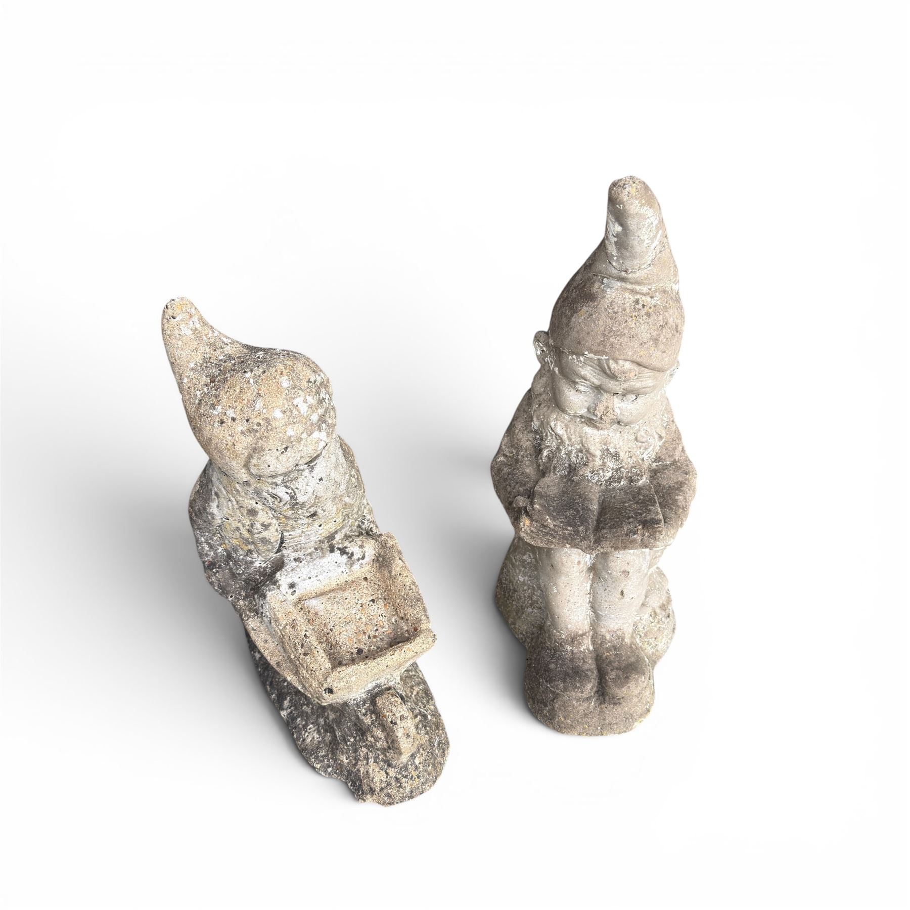 Two seated cast stone garden gnomes
