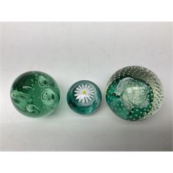 Three millefiori paperweights, together with a green glass dump paperweight with air bubble inclusions, Caithness Daisy and Cauldron paperweights and two small Caithness glass vases, tallest H9cm