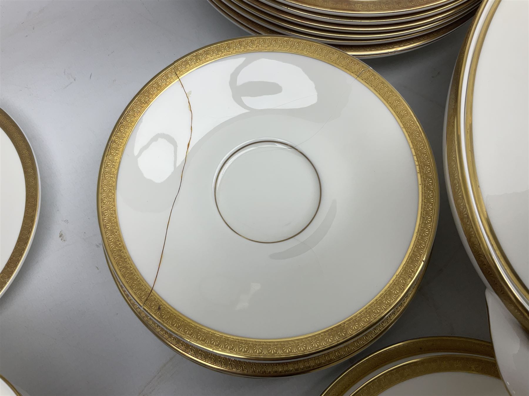 Royal Doulton Royal Gold pattern tea and dinner service for eight, comprising dinner plates, side plates, tea plates, soup bowls, sauce boat and saucer, dessert bowls, coffee cans and saucers, teacups and saucers and two lidded tureens
