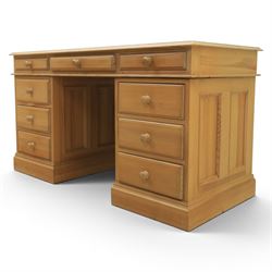 Solid pine twin pedestal desk, fitted with nine drawers, fielded panelled sides
