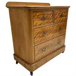 Victorian satin walnut chest, raised back over two short and two long drawers, skirted base with castors