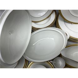 Royal Doulton Royal Gold pattern tea and dinner service for eight, comprising dinner plates, side plates, tea plates, soup bowls, sauce boat and saucer, dessert bowls, coffee cans and saucers, teacups and saucers and two lidded tureens