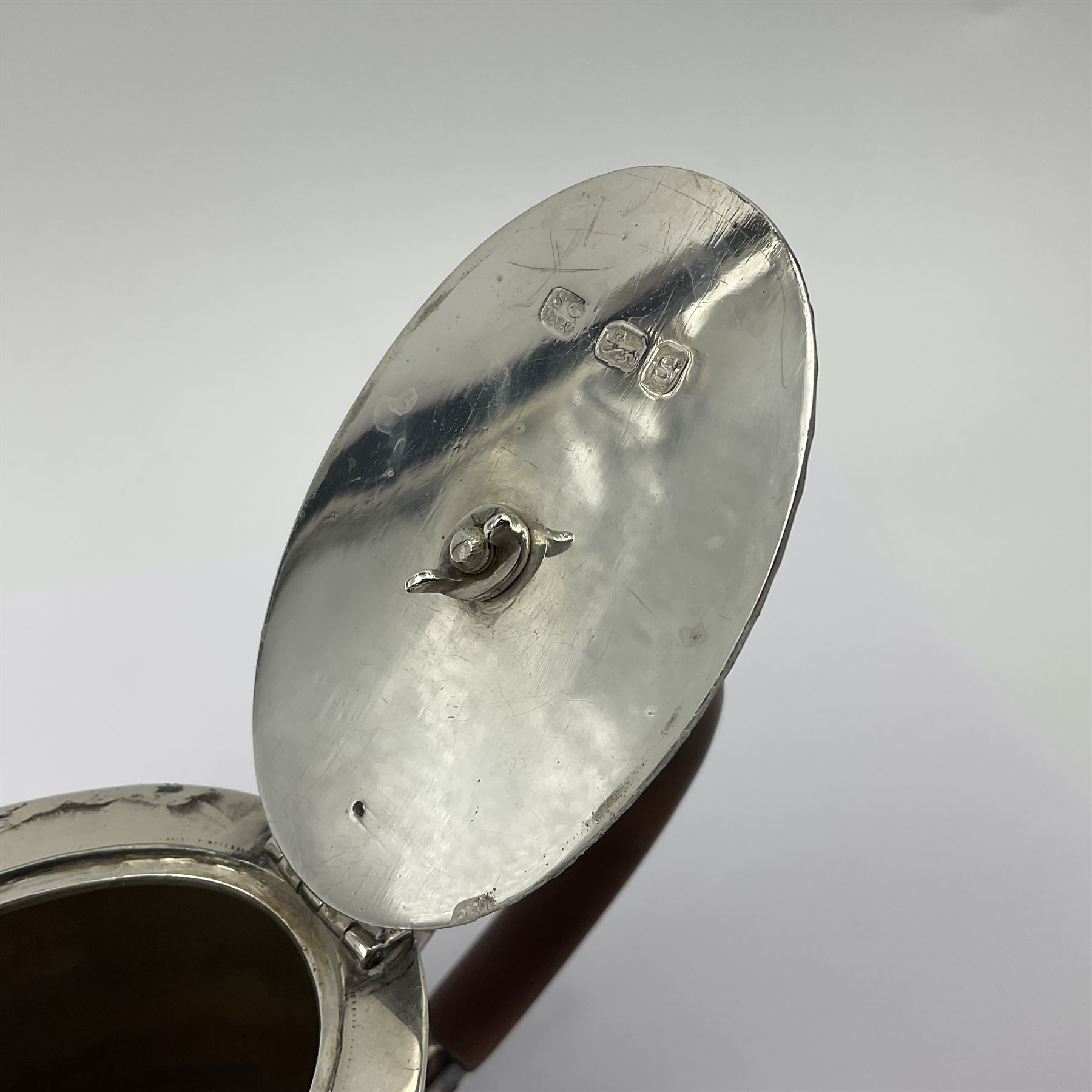 George III silver bachelors teapot, of oval form with wooden scroll handle and finial, the body chased with armorial crest and ribbon swag and foliate detail, hallmarked Samuel Godbehere & Edward Wigan, London 1793, including handle H9cm