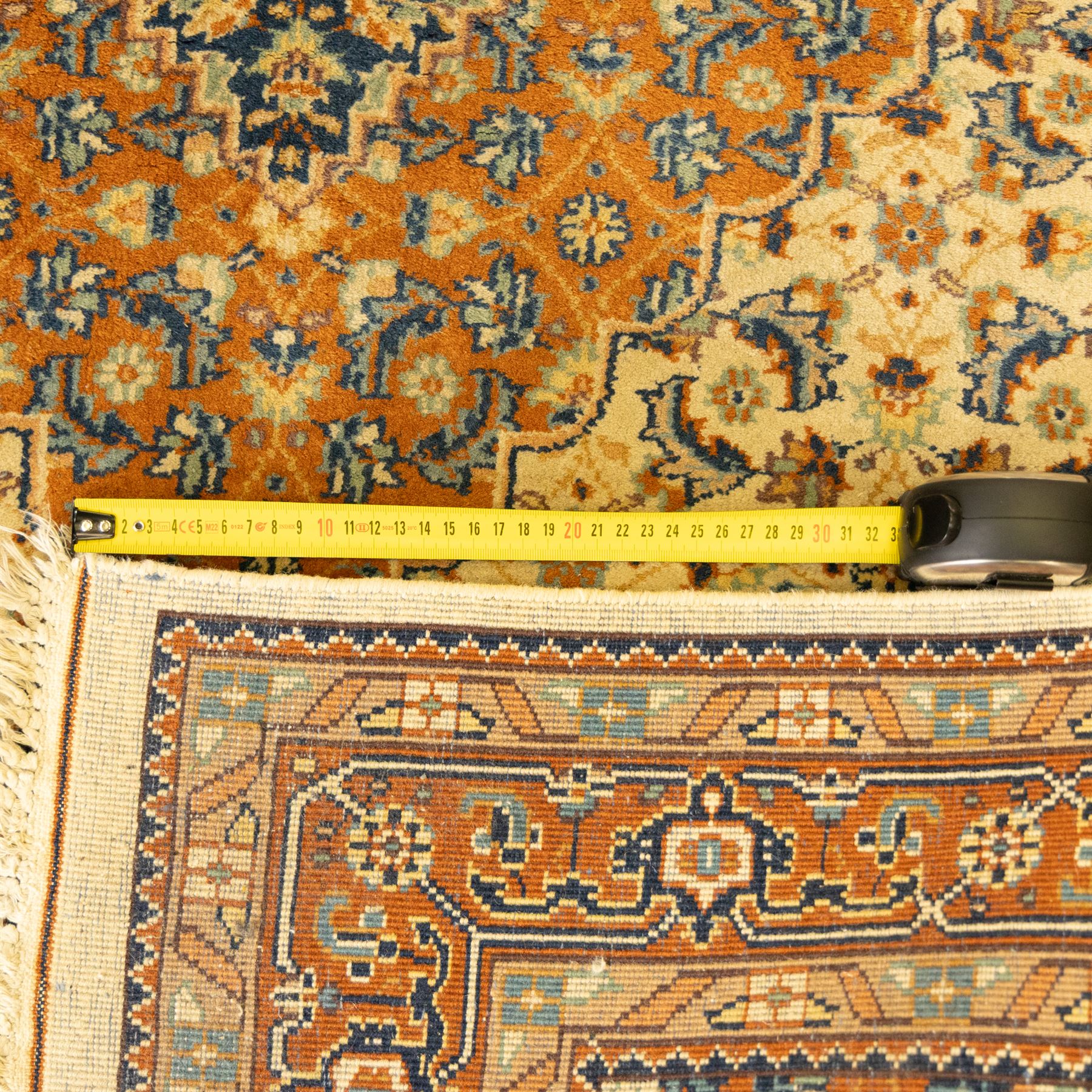 Persian Bijar rug, ivory field profusely decorated with a dense all-over Herati pattern centered by a red medallion with indigo lozenge and spandrels framed by a rust ground border of stylized palmettes and rosettes, between narrow floral guards