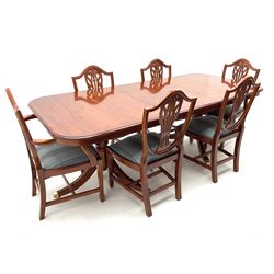 Yew wood twin pedestal extending dining table, shaped supports and brass castors (W216cm, D100cm, H77cm) and six (4+2) chairs, shaped back and upholstered in patterned fabric raised on fluted supports (W52cm)