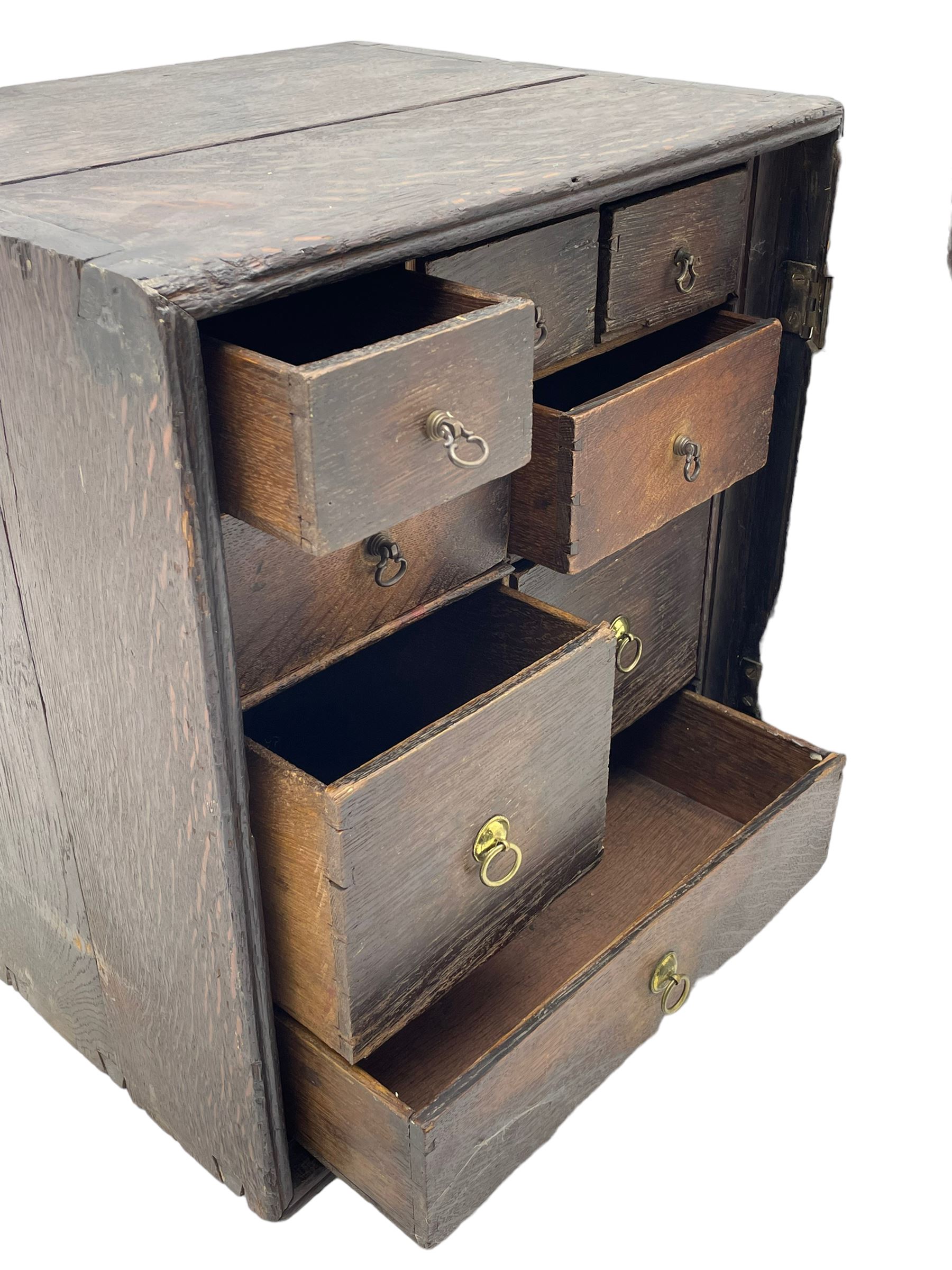 18th century oak spice cupboard, single panelled door enclosing eight drawers of various sizes, reed moulded front edges