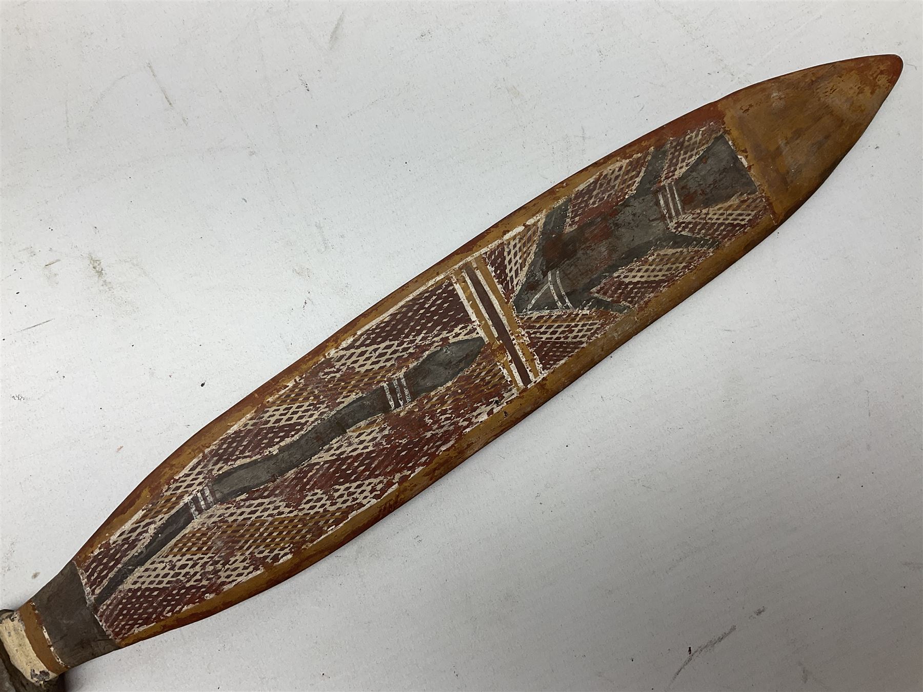 Australian Aboriginal shield, carved with Kangaroo and Emu, 74.5cm; Spear painted with aquatic creatures 78cm, and Spear thrower 81cm (3)