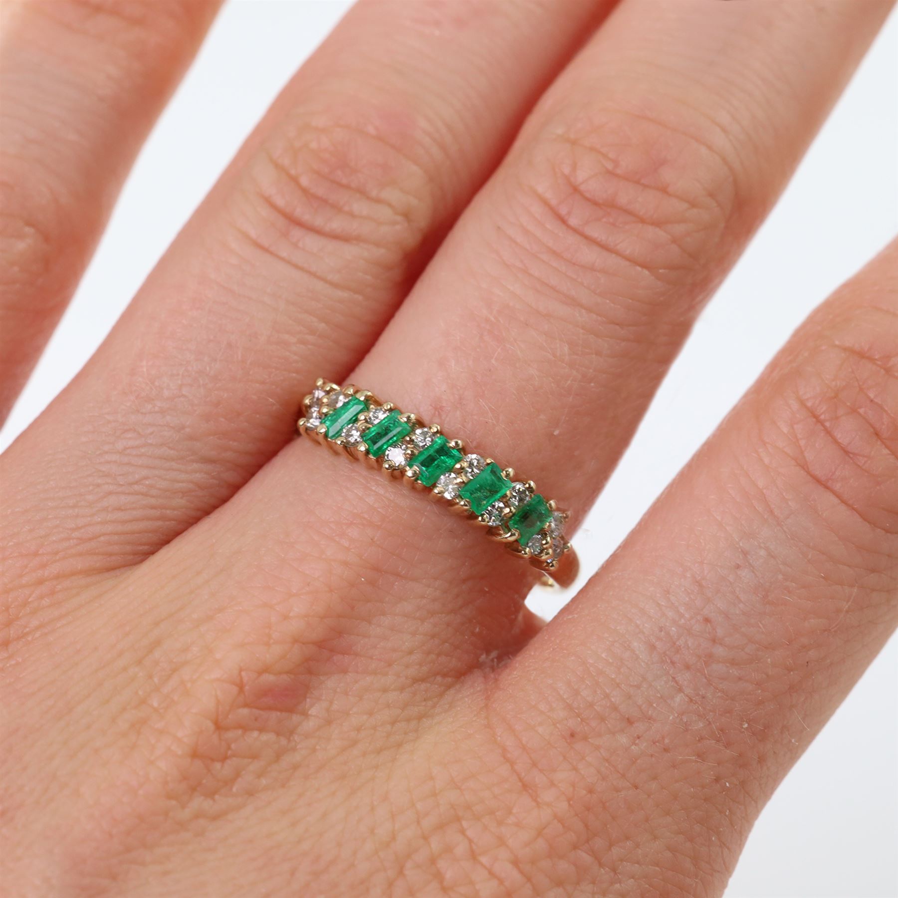 9ct gold emerald and diamond ring, set with five baguette cut emeralds and fourteen round brilliant cut diamonds, hallmarked 