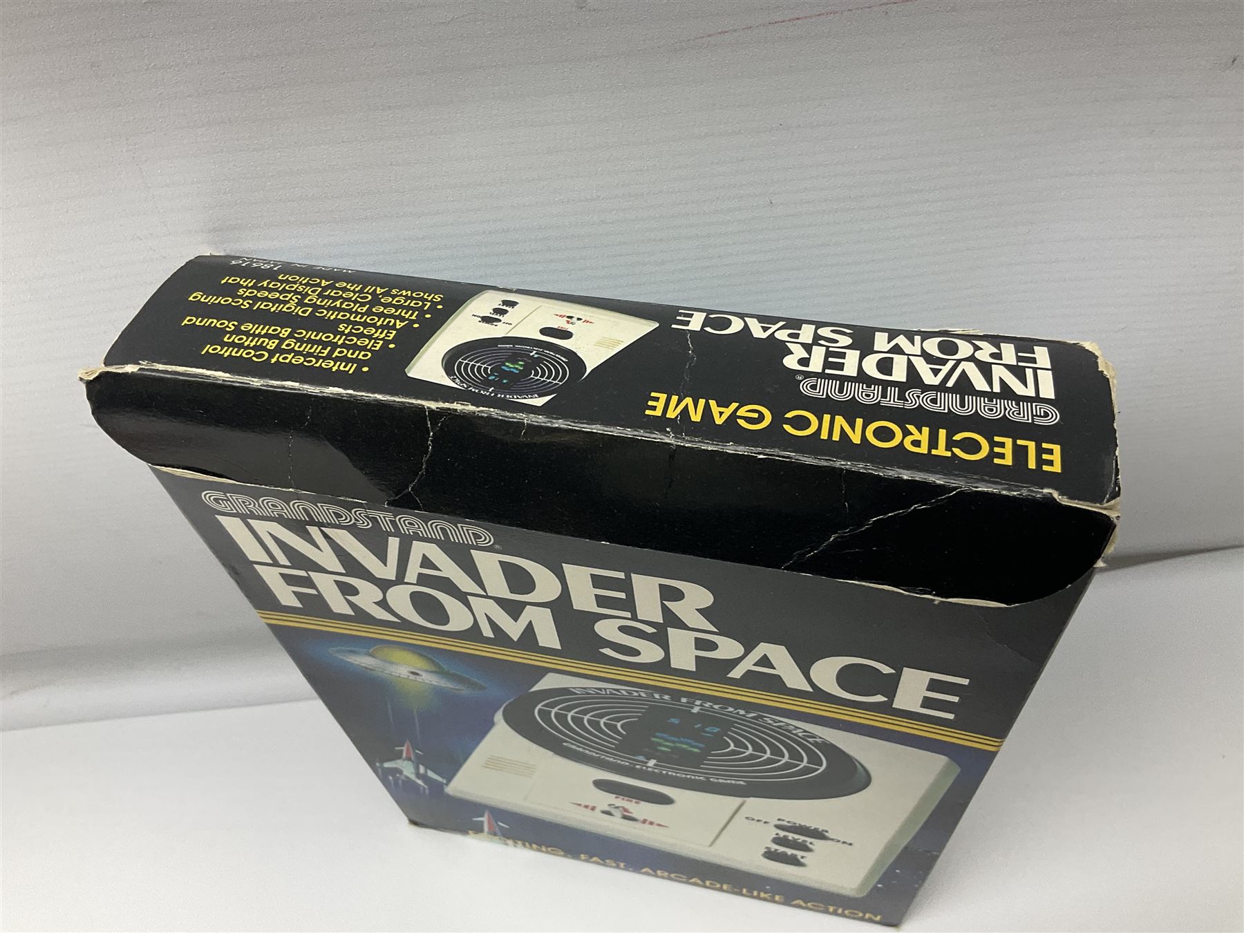 Three late 70s/early 80s handheld electronic games; Bandai Electronics Arcade ‘Gunfighter’ (1980), Grandstand ‘Invader From Space’ (1980), Palitoy ‘Merlin The Electronic Game Machine’ (1979) with game sheet and instruction booklet, all with original boxes (3) 