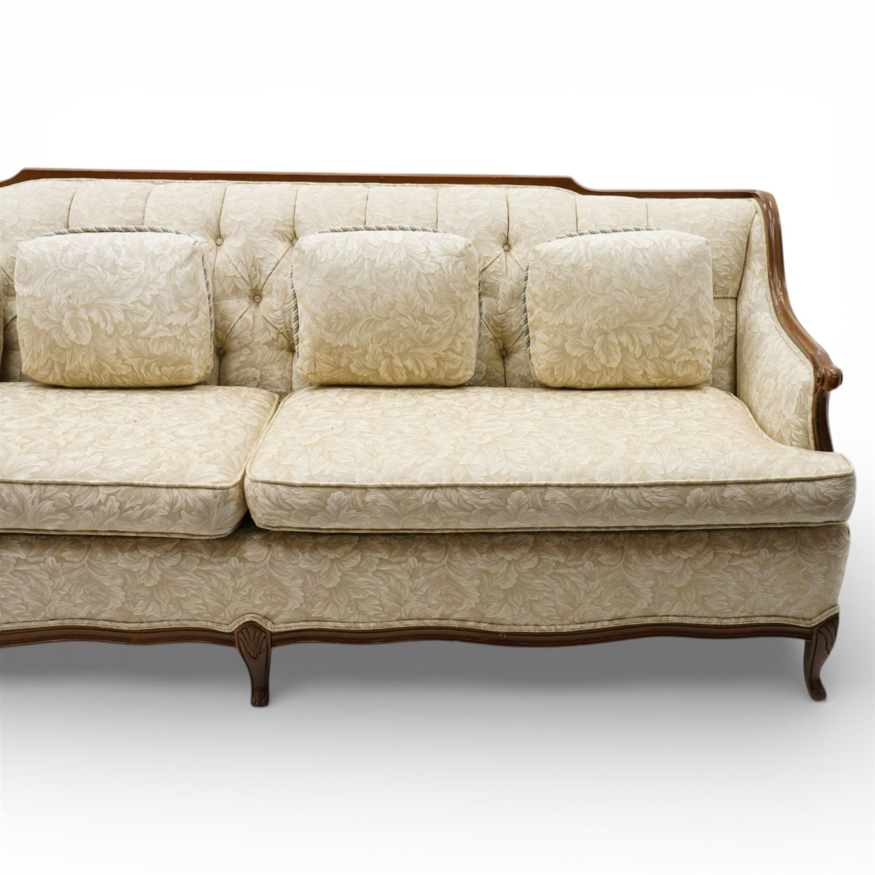 Mahogany framed three seat sofa in the Louis XV style, the shaped buttoned back above loose seat cushions and scrolling arms, raised on cabriole legs with shaped apron