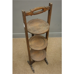 Early 20th century oak folding cake stand and an oak fire screen with floral tapestry  