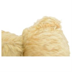 Early 20th century musical teddy bear, with golden mohair head and body, pronounced clipped muzzle, humped back, one eye, black/brown stitched nose, mouth and claws, swivel head and jointed limbs, containing pressure operated musical mechanism, L51cm

Notes by vendor repute: Previously owned by Dame Christian Howard of Castle Howard and given by her in the 1960s to the vendor who was the child of her house keeper.