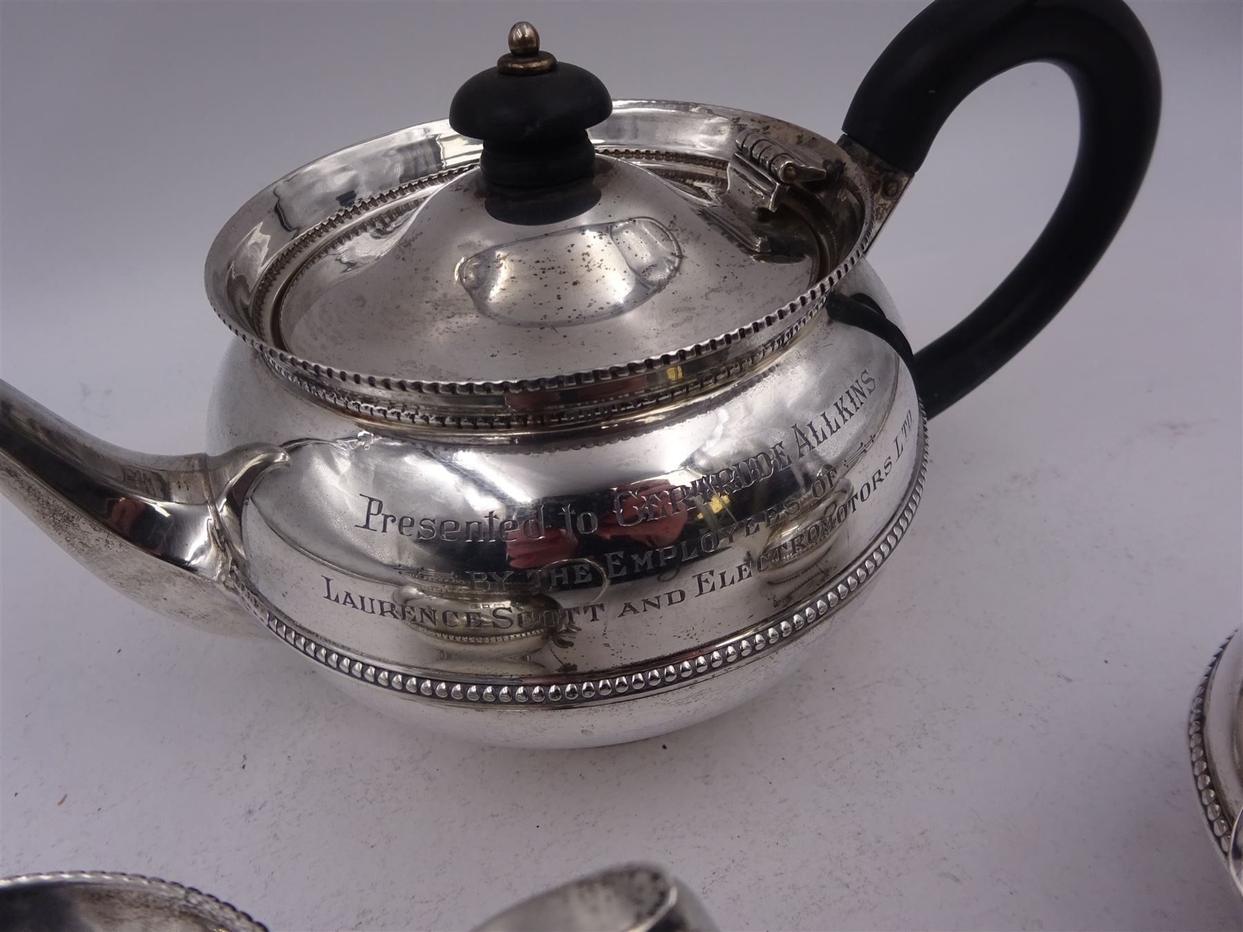 1920s silver three piece bachelors tea service, comprising teapot, with Bakelite handle and finial, milk jug and twin handled open sucrier, each with beaded rim and girdle, all with presentation engravings to body, hallmarked Charles Boyton & Son Ltd, London 1926, teapot H11cm