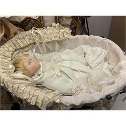 Two decorative wicker dolls prams, one with lace parasol,  and eleven dolls, including Leonardo Collection porcelain dolls, tallest pram including parasol H105cm
