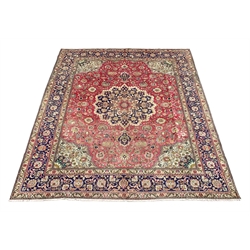 Persian Kashan rug carpet, pale red ground field with overall stylised foliate design, decorated with floral central medallion and spandrels, the blue ground border with six band guard, 370cm x 295cm