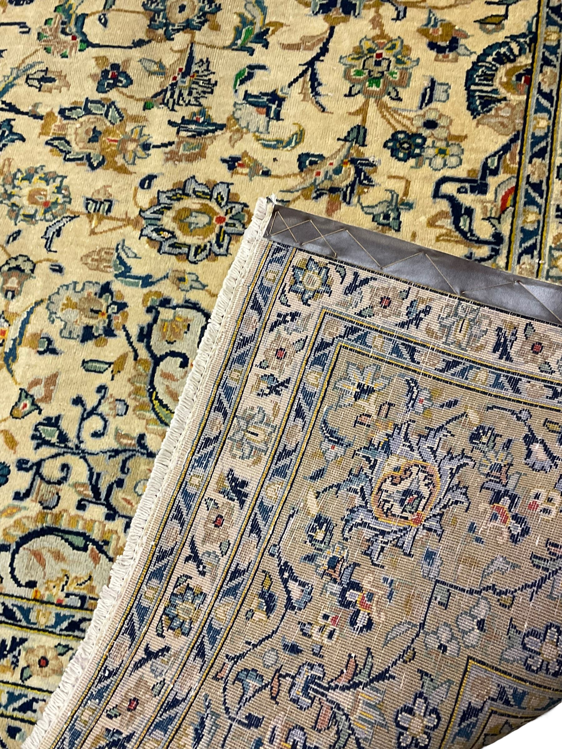 Central Persian Kashan carpet, decorated all-over with interlacing floral design, scrolling border with stylised plant motifs, with signed panel