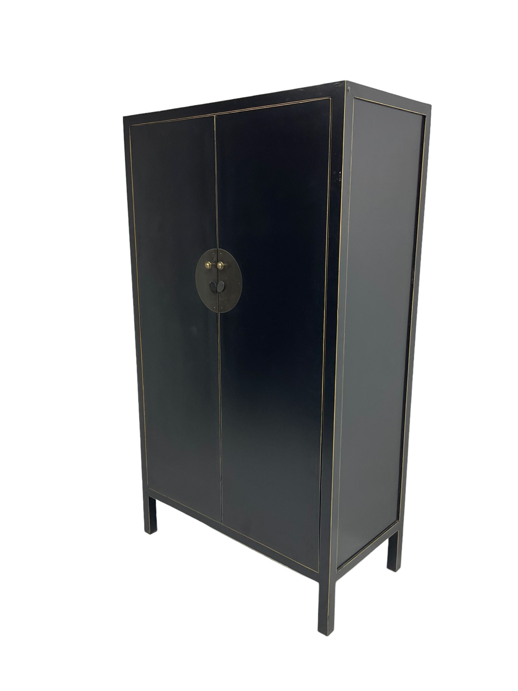 Chinese design black lacquered wardrobe, two cupboard doors enclosing hanging rail and two drawers