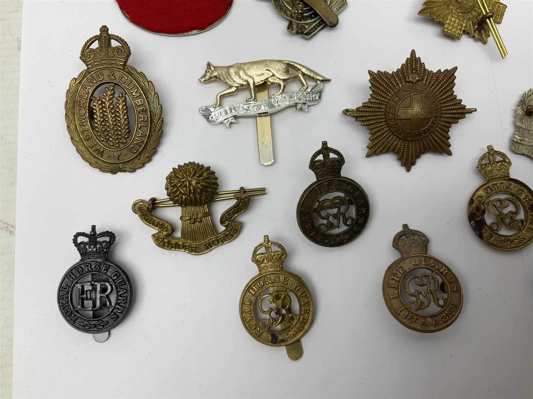 Twenty-six cap badges for Yeomanry and various guards including Fife & Forfar, Lothian and Border Horse, Leicestershire, Northamptonshire, Queens Own, Coldstream, Grenadier, Machine Gun Regiment, Life Guards etc (26)