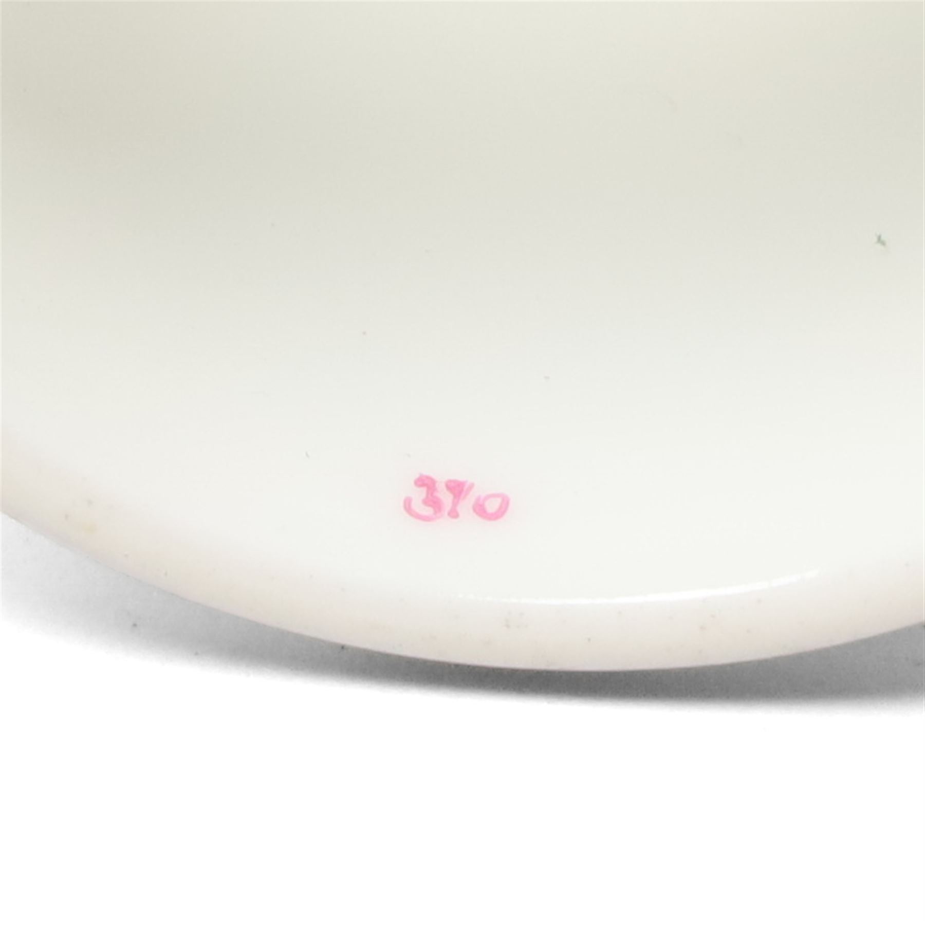Set of twelve Herend porcelain napkin rings painted with trailing flowers and leaves on a moulded ground