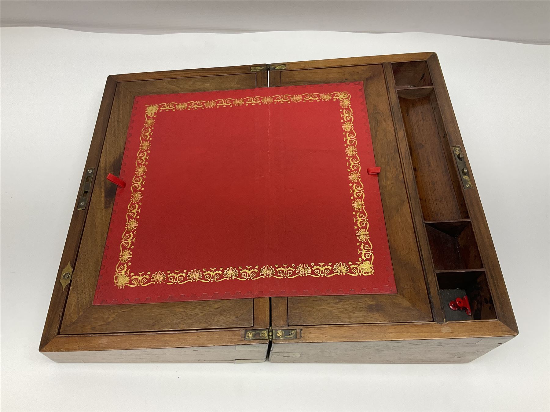 19th century burr yew wood tea caddy, of sarcophagus form, with strung details and brass mounts, the interior split into three compartments, upon four brass bun feet, together with an oak and brass bound writing slope, with red leather interior with gilt detailing, largest H16cm, W40cm